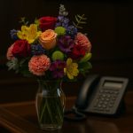 Bouquet of flowers on a diplomatic desk with a phone in the background